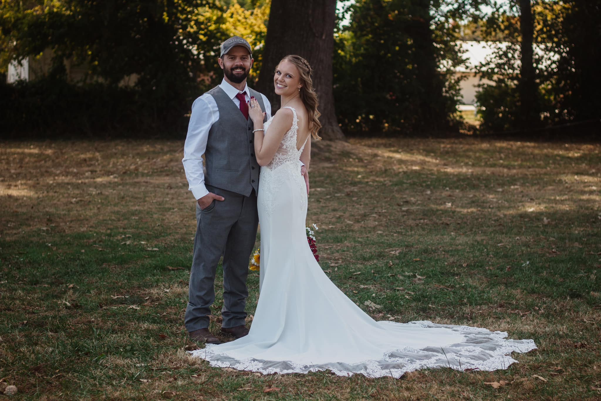 Bride and groom smiling together outdoors at golden hour
