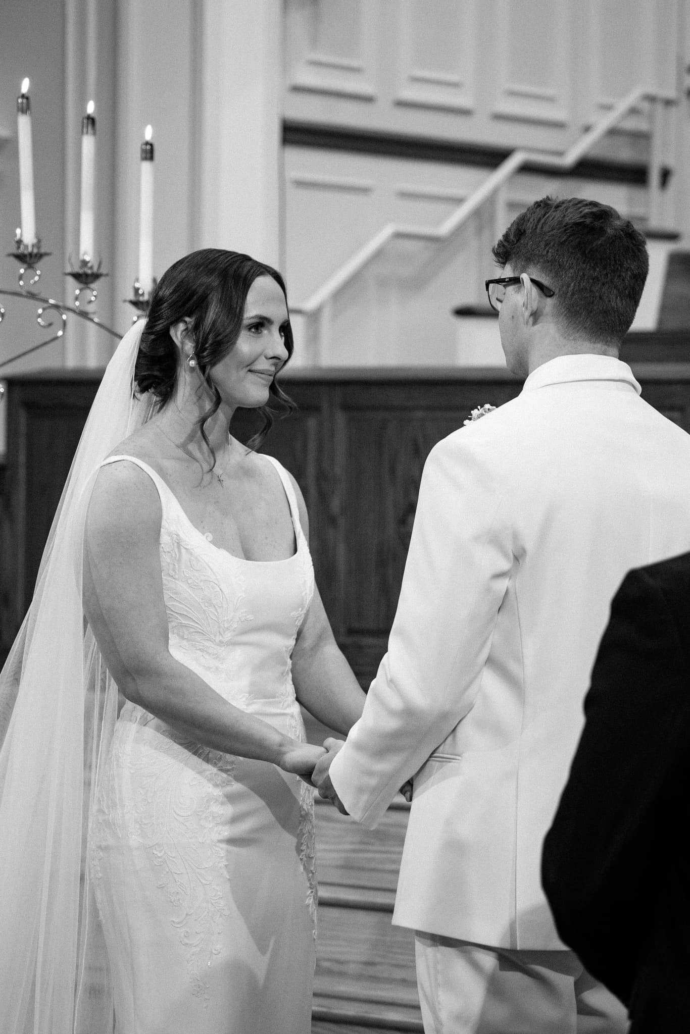 Bride and groom exchanging vows in church
