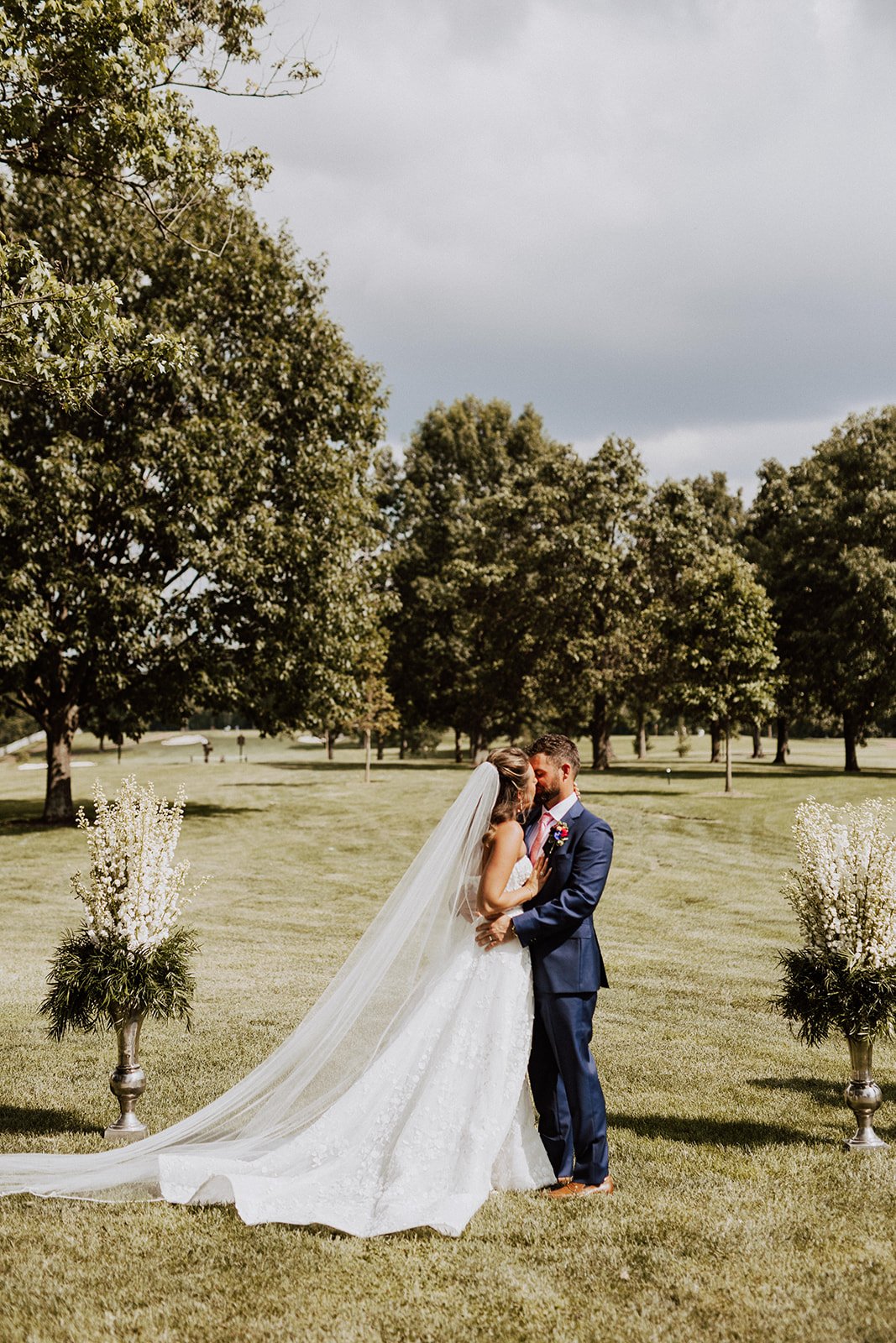 Wedding couple first kiss outdoors