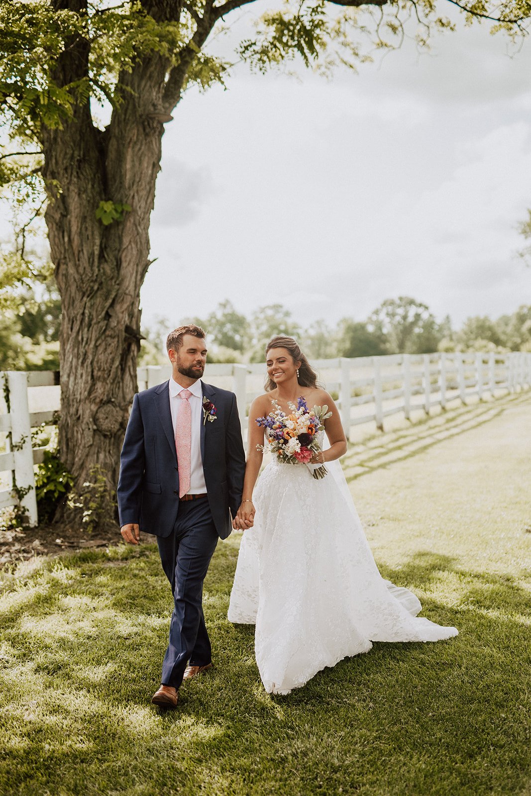 Wedding couple walking through garden